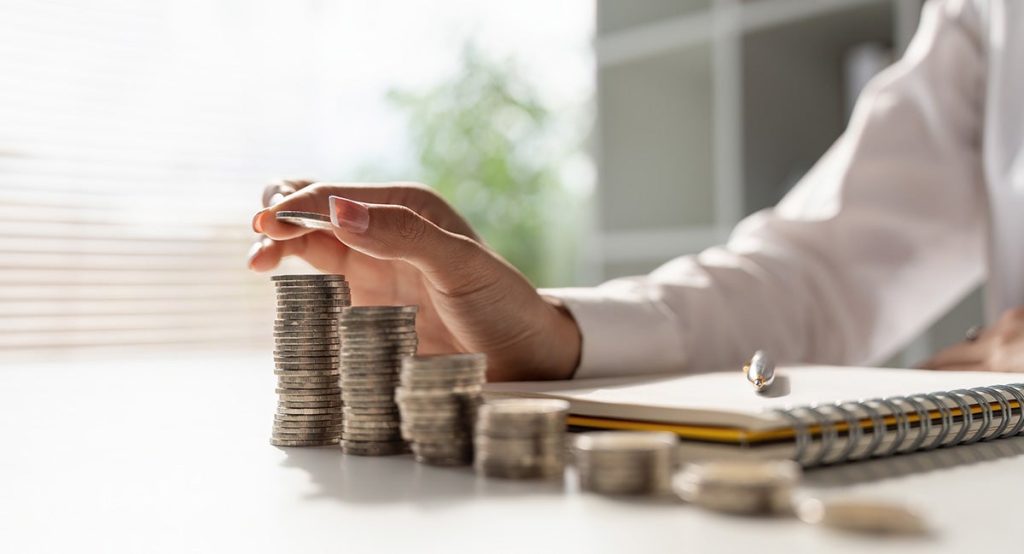 lady stacking coins at a desk