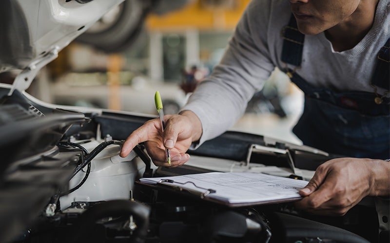 mechanic inspecting an engine for service