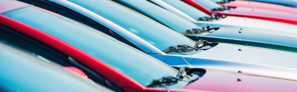 A row of colorful cars parked in a line.